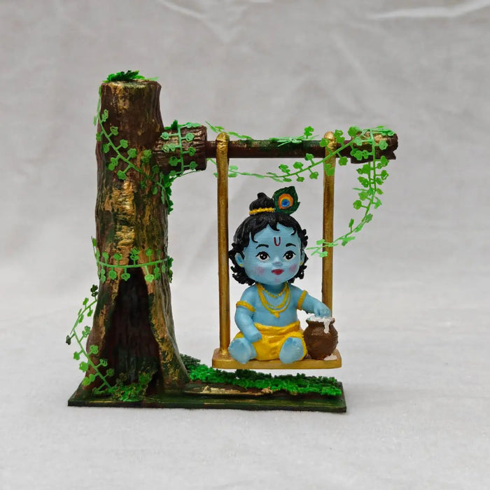 Lord Krishna on Jhula sculpture