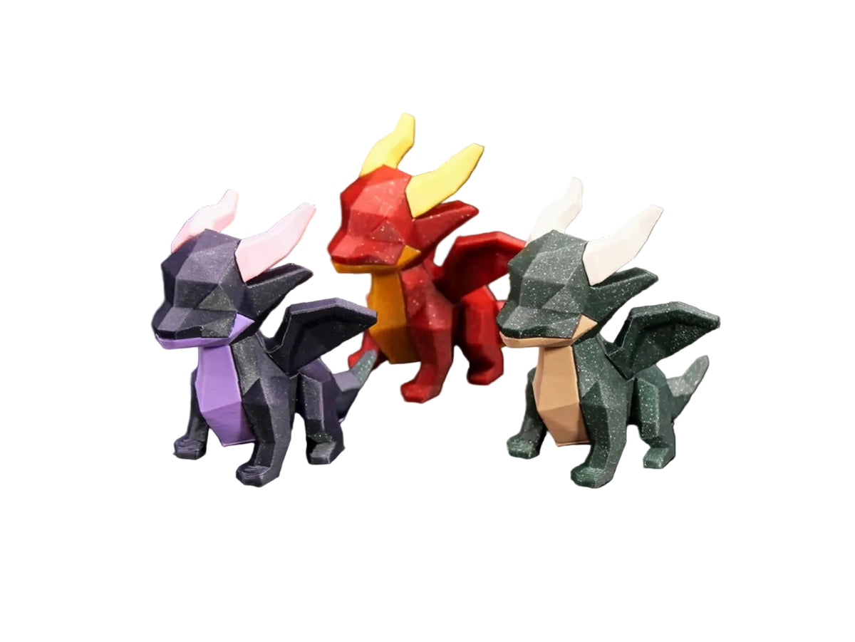 Three low-poly dragon figurines in different colors (dark gray with purple, red with yellow, and dark green with beige) displayed on a black background with the 'Thanabun Lab' logo at the bottom.