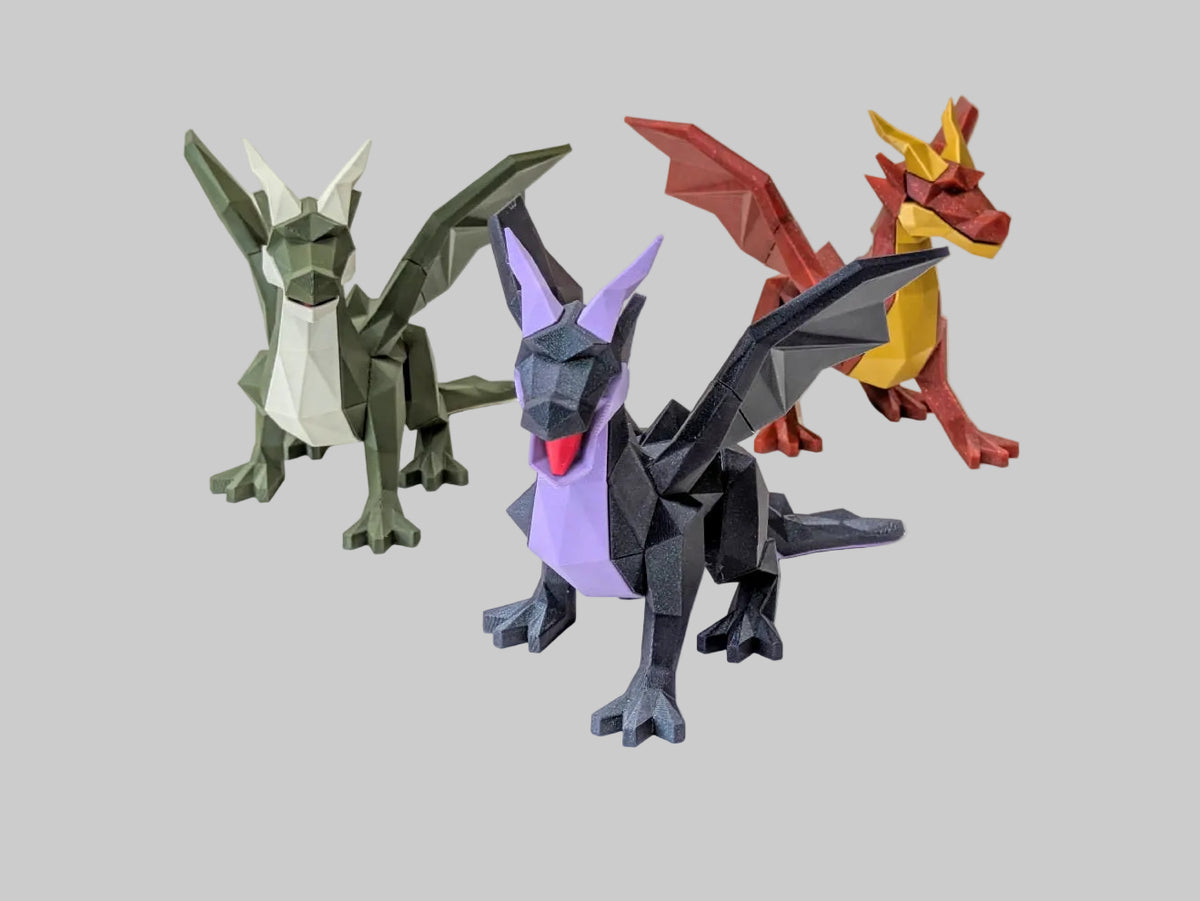 Three low-poly dragon figurines displayed on a white surface against a light gray background, with a 'Manabun Lab' logo at the bottom.